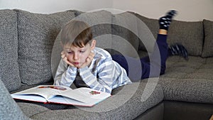 School kid in self isolation using tablet for homework,Bored Child sad face lying head down looking out deep in thought, Boy stay