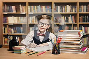 School Kid Studying in Library, Child Writing Book, Shelves photo