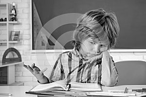 School kids against green chalkboard. Kid gets ready for school. School education and people concept - cute pupil over