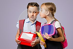 School kids eating healthy food together. schoolchildren with lunch boxes