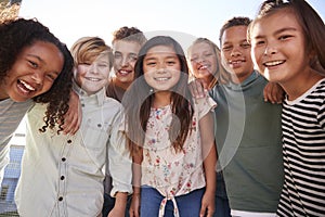 School kids hanging out during break, smiling to camera