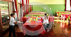 School kids having lunch in canteen