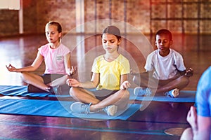 School kids meditating during yoga class