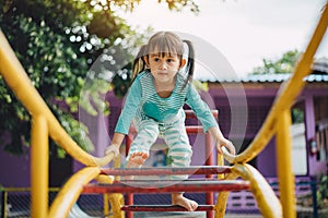 School kids play and learn in the playgound. Physical activity like climbing are good for develop movement and muscle in children