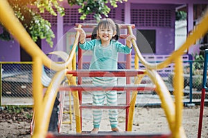 School kids play and learn in the playgound. Physical activity like climbing are good for develop movement and muscle in children