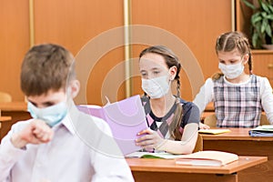 School kids with protection mask against flu virus at lesson