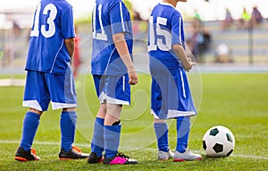 School kids standing in line in a football training class. Children playing sports background