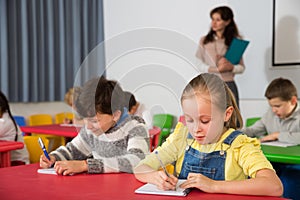 School kids studying in classroom