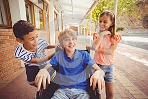 School kids talking to a boy on wheelchair