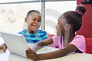 School kids using a digital tablet in classroom