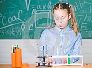 School laboratory. Girl smart student conduct school experiment. School pupil study chemical liquids. School chemistry