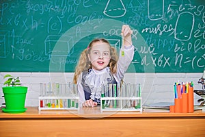 School lesson. Interesting approach to learn. Girl cute school pupil play with test tubes and colorful liquids. School