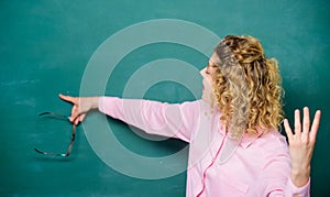 School lesson knowledge. Remember this. Strict woman teacher pointing at chalkboard. Informing kids. School rules photo