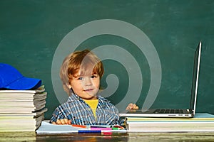 School lessons. Kid is learning in class on background of blackboard. Teachers day. Home schooling. School and education