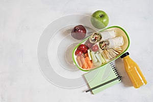School lunch box with sandwich, vegetables, water, fruits Healthy eating habits concept - background layout with free text space.