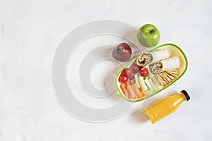 School lunch box with sandwich, vegetables, water, fruits Healthy eating habits concept - background layout with free text space.