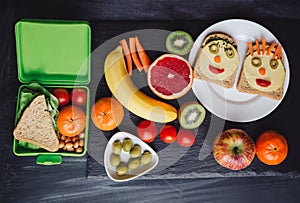 School lunch boxes with sandwich and fresh vegetables