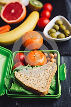 School lunch boxes with sandwich and fresh vegetables