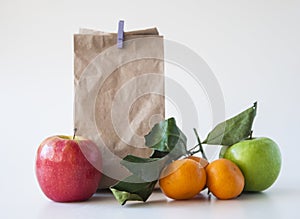 School lunch. Brown paper breakfast bag and mixed fruit