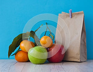 School lunch. Brown paper breakfast bag and mixed fruit
