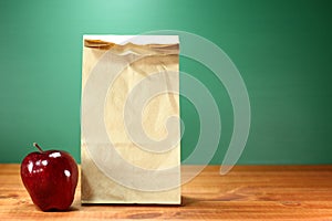 School Lunch Sack Sitting on Teacher Desk