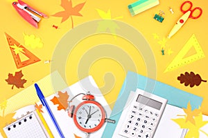 School office supplies,accessories on yellow background top view.Back to school concept empty copy space