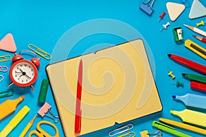 School office supplies on a desk with copy space. Back to school concept. School supplies on blue background. Back 2 school