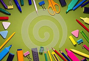 School office supplies on a desk with copy space. Back to school concept. School supplies on green background. Back 2 school