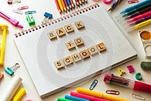 School office supplies and opened notebook on a desk