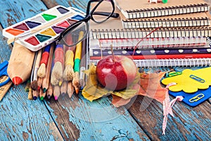 School, office supplies on a wooden background