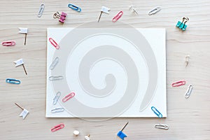 School office supplies on wooden background. Back to school concept. White board with hands for copy space. Top view ready for