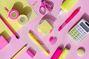 School and office supplies on a yellow-pink background