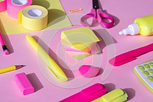 School and office supplies on a yellow-pink background