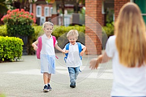 School pick up. Mother and kids after school