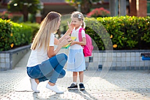 School pick up. Mother and kids after school