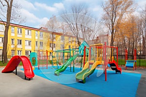 school playground with colorful swings, slides and seesaws