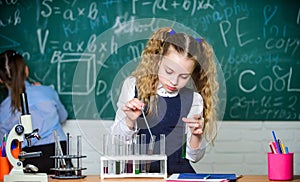 School pupil study chemical liquids. School chemistry lesson. Test tubes with substances. Future microbiologist