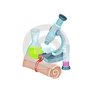 School related items. Microscope, flasks with liquids and rolled paper. Laboratory equipment. Chemistry and biology