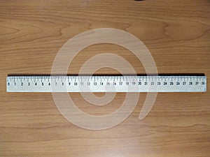 School ruler on wooden background