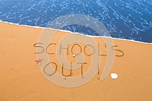 School`s out written in the sand