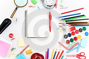 School set with notebooks, pencils, brush, scissors and apple on white background