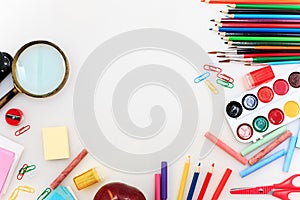 School set with notebooks, pencils, brush, scissors and apple on white background
