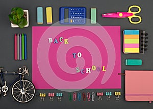 School set with pink paper, text `Back to school` of wooden letters, bicycle model, calculator, crayons, scissors, note pad