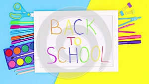 School stationery appear under white frame with back to school title. Stop motion