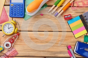 School stationery on wooden background with copy space.