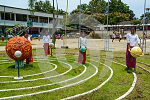 School student girls playing solar system orbit game