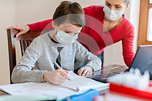 School student learning in video chat with teacher in e-learning