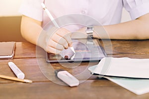 School student using touchscreen tablet computer device to learning and writing homework, modern technology for education