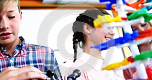 School students experimenting molecule model in laboratory