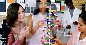 School students experimenting molecule model in laboratory